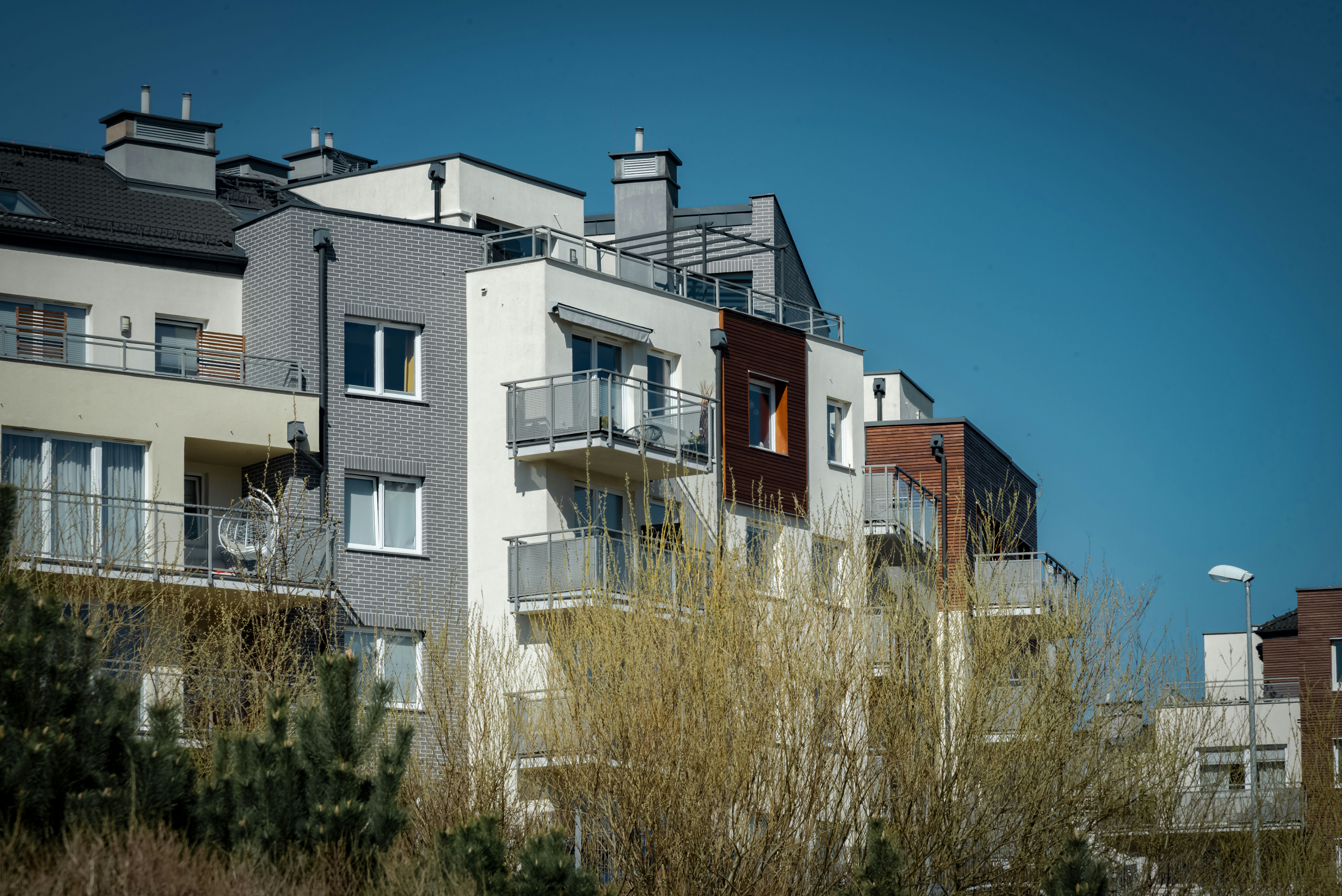 Modern apartment buildings with balconies under blue sky